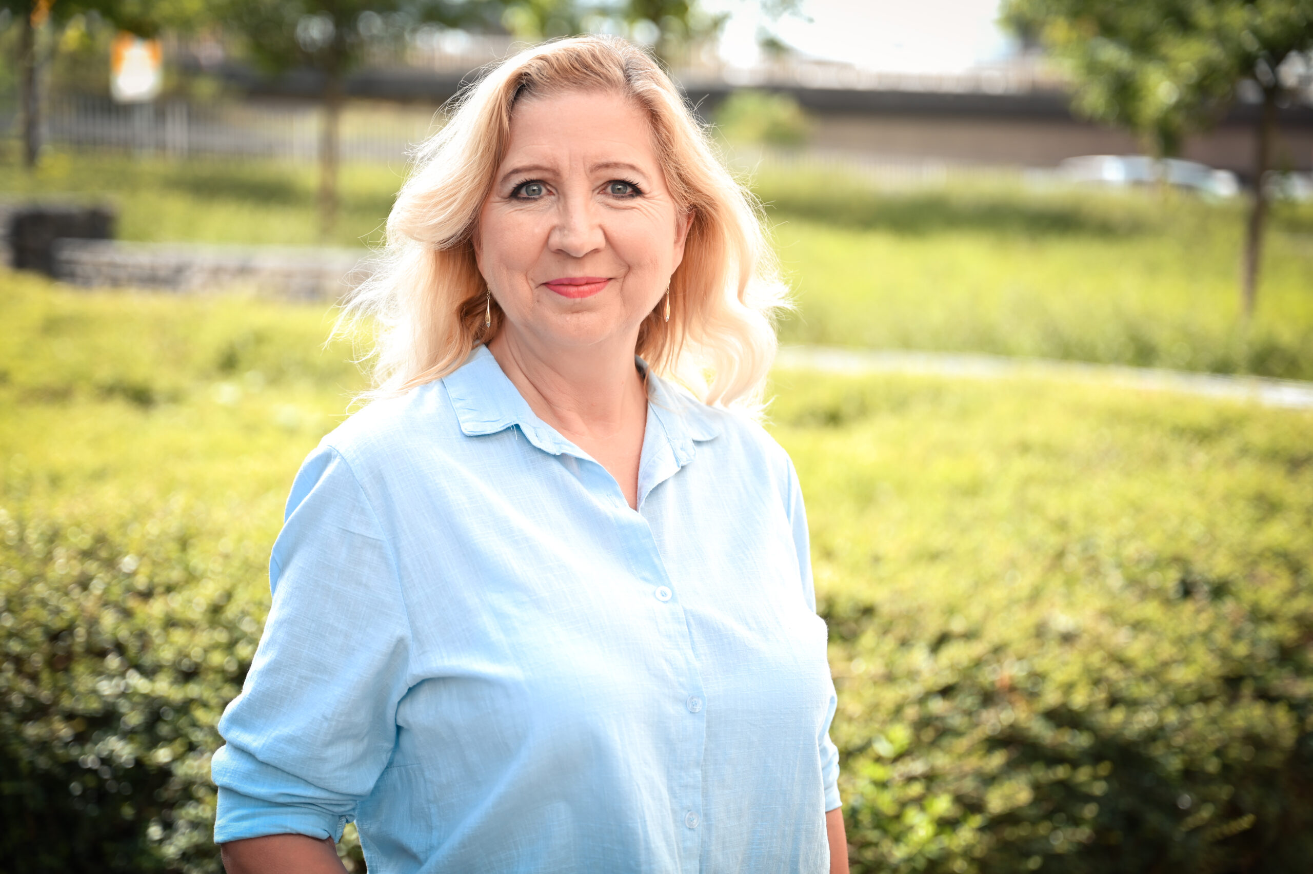 Frau Bergmann-Drolsbach lächelt in die Kamera in der Natur